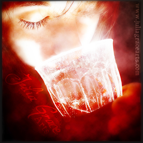 Woman drinking glowing red wine from a glass