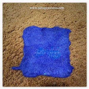 A square of wet felted blue wool